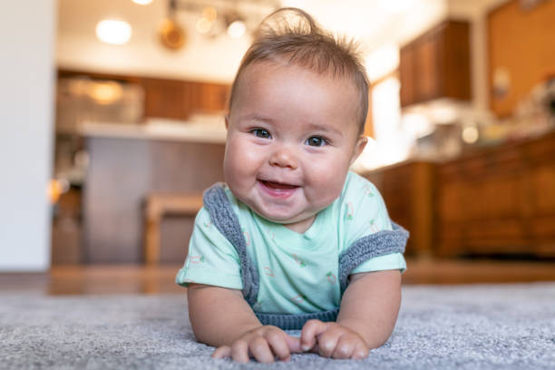 Baby lying on carpet flooring | Key Carpet Corporation